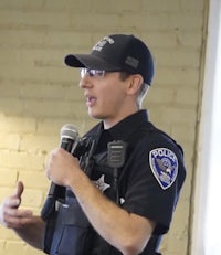 a police officer speaking into a microphone