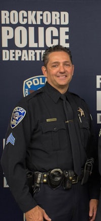 two police officers standing in front of a rockford police department banner