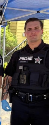 two police officers standing next to each other under a tent