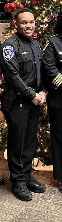 three police officers standing in front of a christmas tree