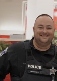 a man in a police uniform smiling in a store